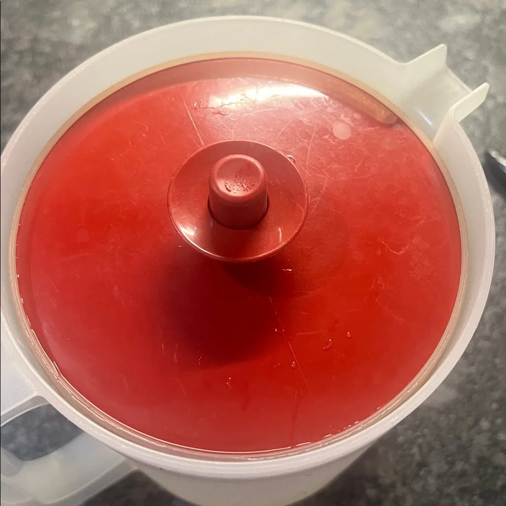 1 1/2 qt semi sheer And Brick Red Plastic Pitcher by Tupperware. Push button lid